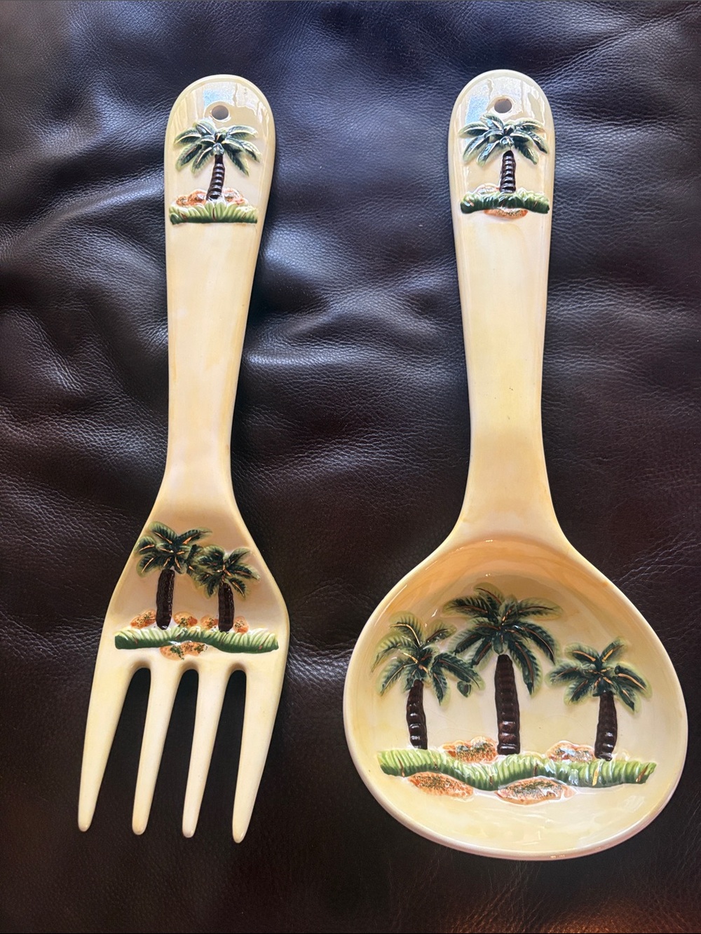 Ceramic Tropical Spoon & Fork Wall Hangings. Light Yellow Background